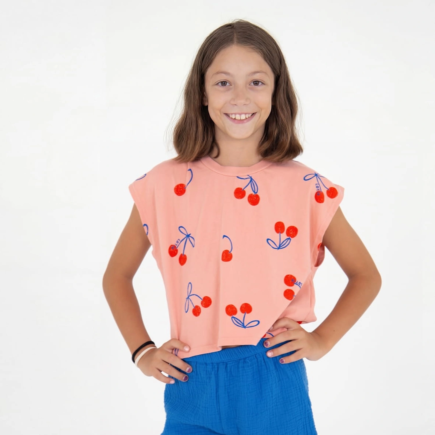 alt="Kids summer pale pink top colour with cherries all over print".